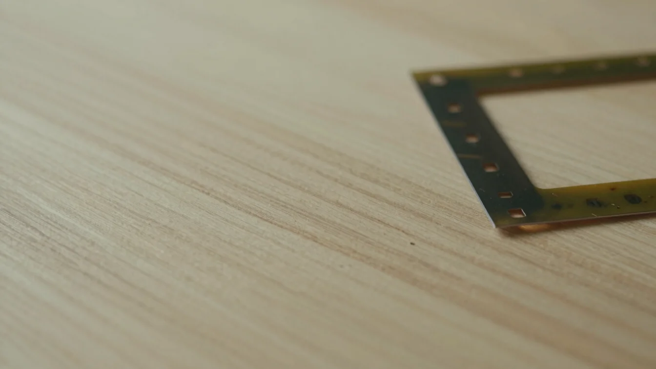 Tactile close-up of raw wood grain and bamboo fibers beside a fol